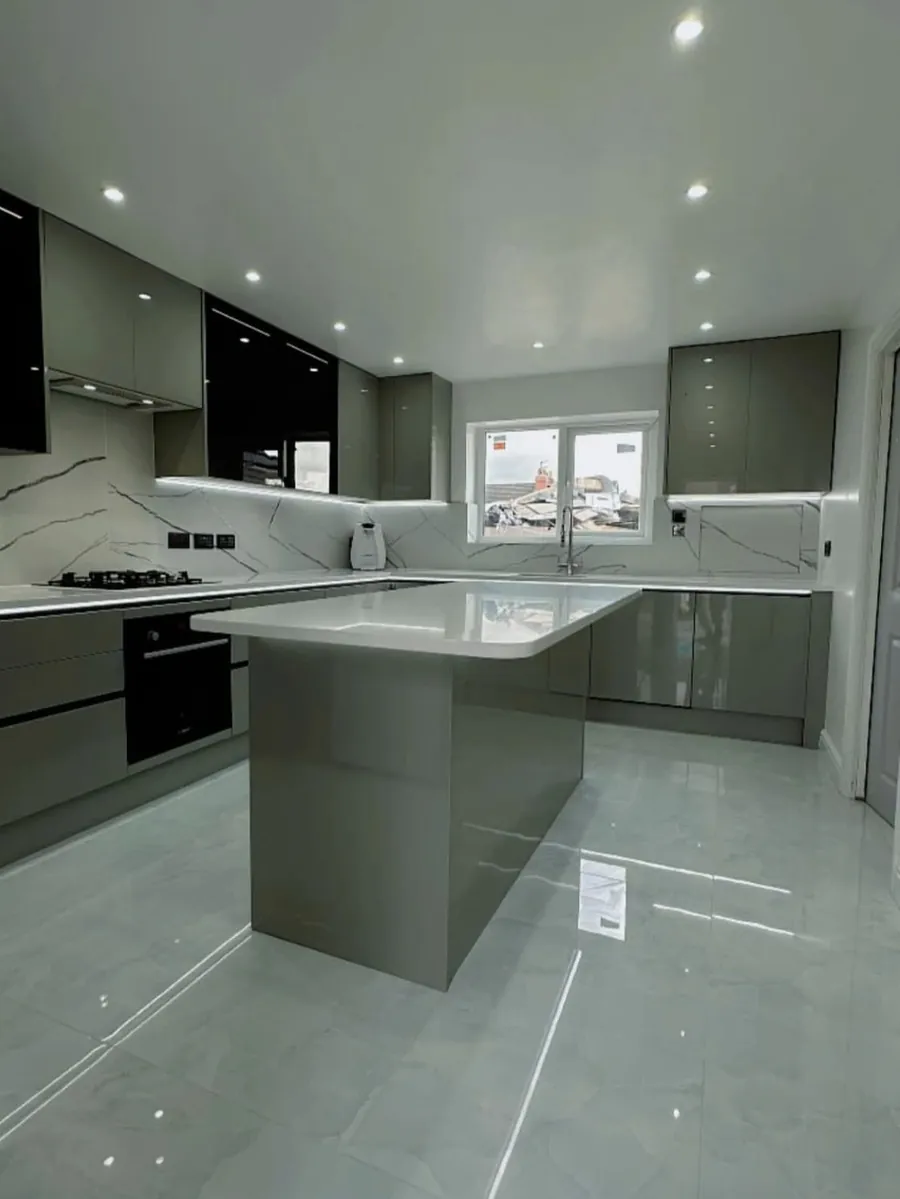 Finished kitchen with grey gloss units, island and marble-effect worktops